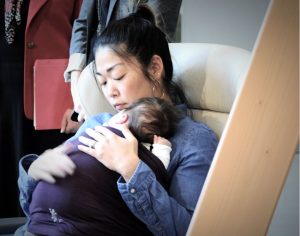 Mother practicing KMC with her baby using a wrap provided by the hospital.