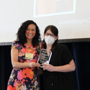 Dr. Angela Kaida presents the award for Champion in Women’s Health Research to Address Shared Global Challenges (Early Career) to Dr. Julia Smith