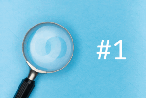 A magnifying glass on a blue background with the #1 in white text