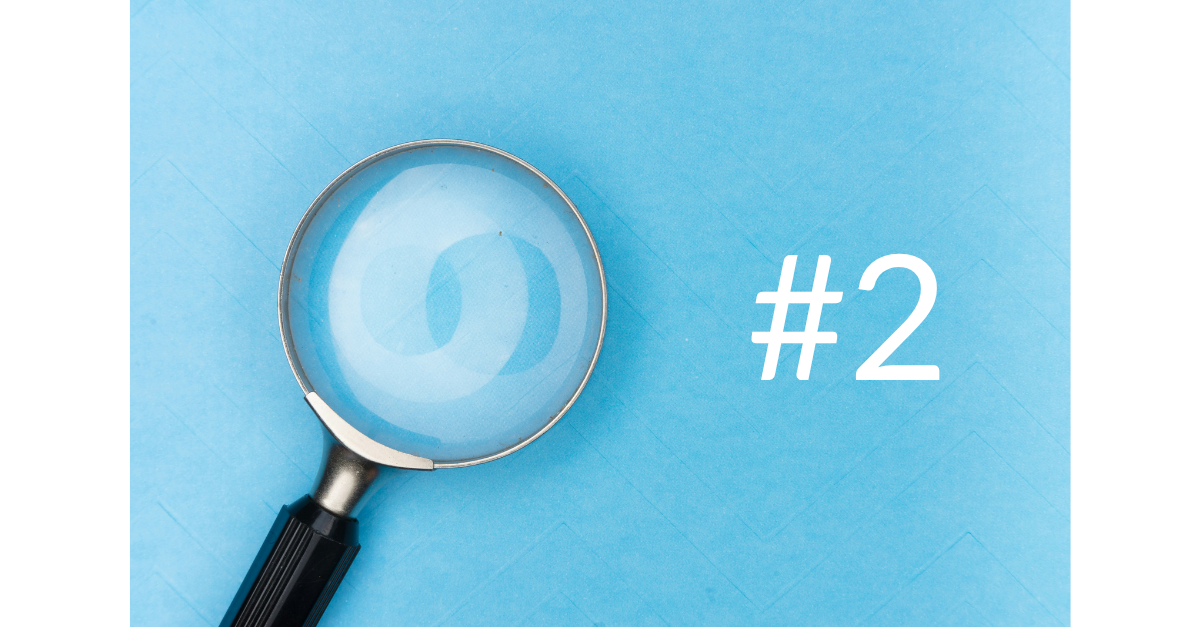 A magnifying glass with the number 2 next to it