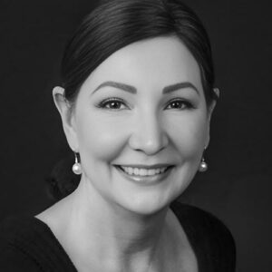 A photo of Dr. Cheryl Lea Wellington in black and white. Dr. Wellington is smiling.