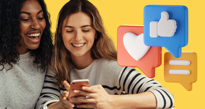 A photo of two people looking at content on a smartphone.