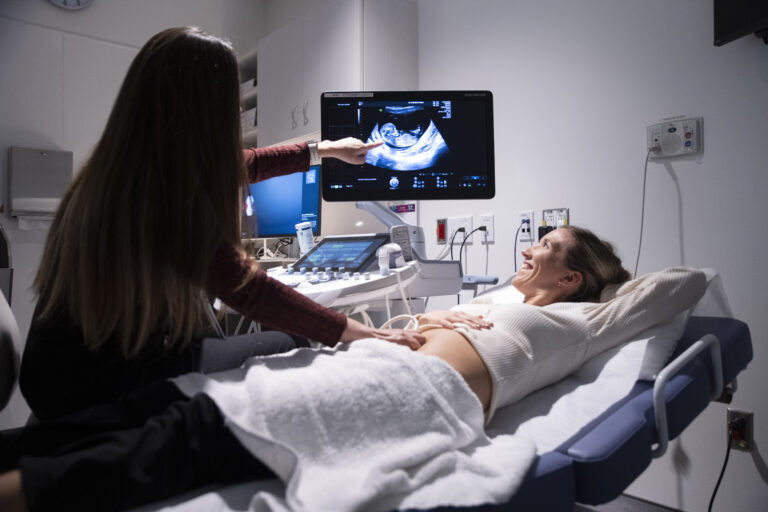 A photo of a person receiving an ultrasound in a medical facility